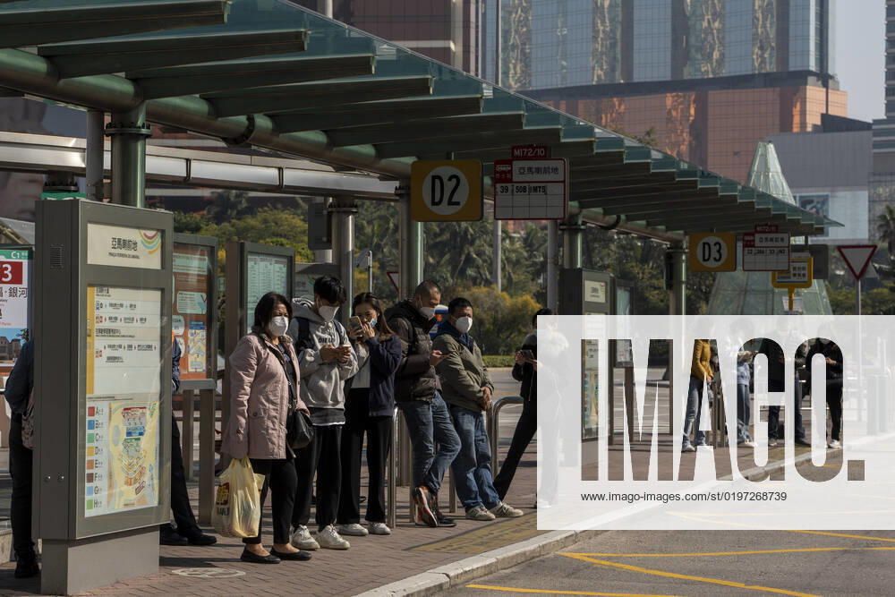 Daily Life In Macau Commuters wearing face masks while waiting for a bus at a bus stop on December 29, 2022 in Macau, China. Macau Macau