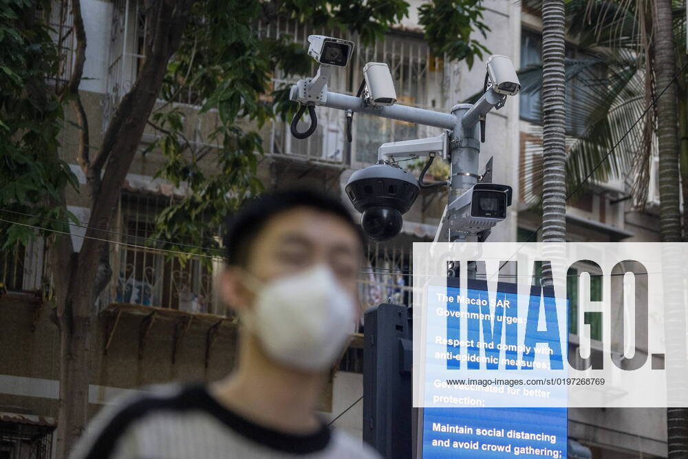 Daily Life In Macau A man wearing face mask walks in front of a dozen of CCTV Camera on December 29, 2022 in Macau, China. Macau Macau