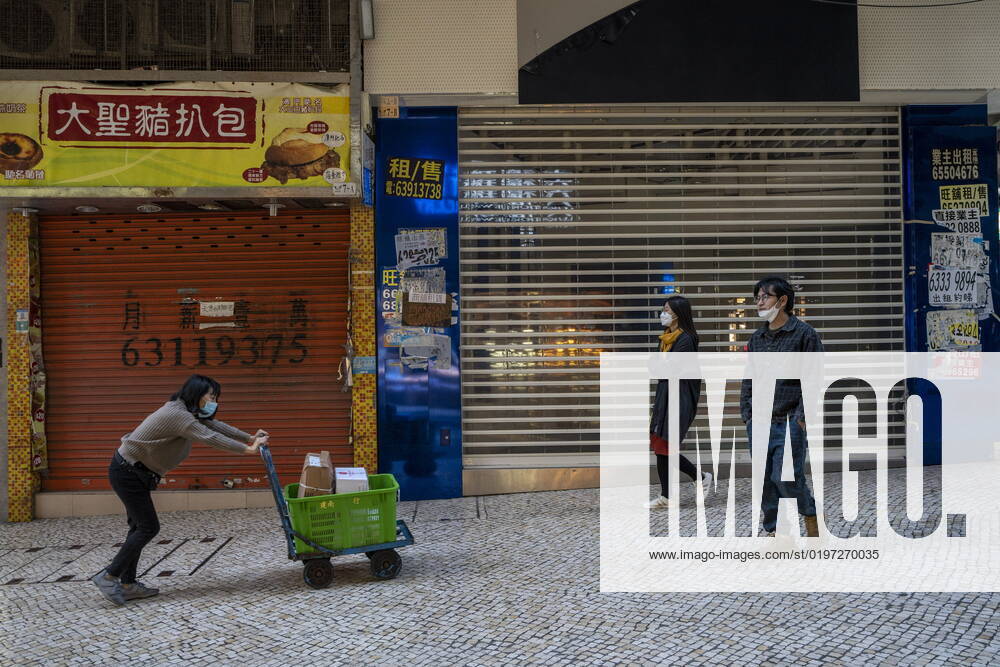 Daily Life In Macau People wearing face masks walk pass closed stores on December 29, 2022 in Macau, China. Macau Macau