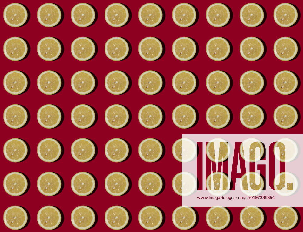 Pattern of halved lemons flat laid against red background, GIOF15643