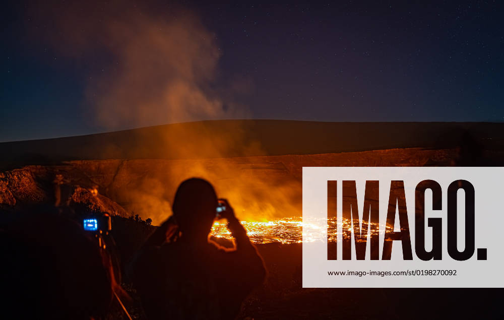 VOLCANO, HI - January 7, 2023: Spectators observe the eruption pictured as Hawaii?s Kilauea volcano eruption continued after re-erupting on January 5th in Volcano, HI on January 7, 2023.