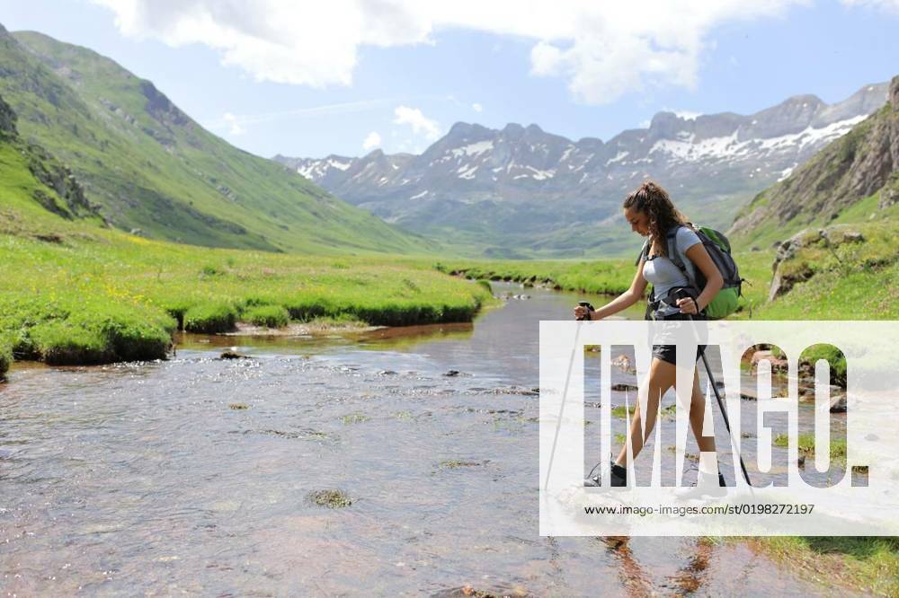 Hiker ready to cross a river in the mountain, Full body portrait of a hiker ready to cross a river in the mountain, Full body portrait of a hiker ready to cross a river in the mountain model released, Symbolfoto , 31.10.2022,