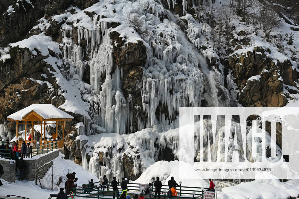 Tourists enjoy near a frozen waterfall in the Drang area of Tangmarh on January 16, 2023 in Baramulla, India. The famous Drang waterfall next to Gulmarg has completely frozen due to minus temperatures. Snowfall in Kashmir had led to a high influx of tourists into the valley, especially at Drang in Gulmarg. Drang, a small village, is a beautiful tourist spot in the Tangmarg tehsil of Gulmarg, Baramulla. It is around 47 kilometres away from the capital city of Srinagar. The drive towards Drang although runs through a deep pine forest with the old mud houses around. (Photo by Waseem Andrabi Hindustan Times) Tourists Enjoy Frozen Waterfall Of Drang Near Gulmarg