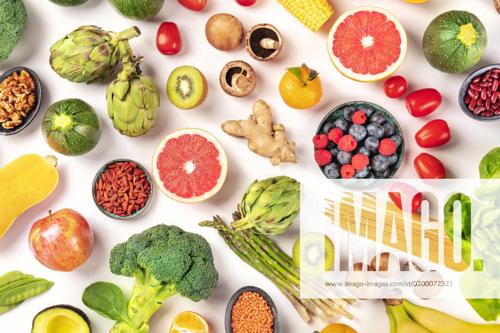 Vegan food. Healthy diet concept. Fruits, vegetables, pasta, nuts, legumes, mushrooms, shot from the top on a white background. A flat lay composition Vegan food. Healthy diet concept. Fruits, vegetables, pasta, nuts, legumes, mushrooms, shot from the top on a white background. A flat lay composition