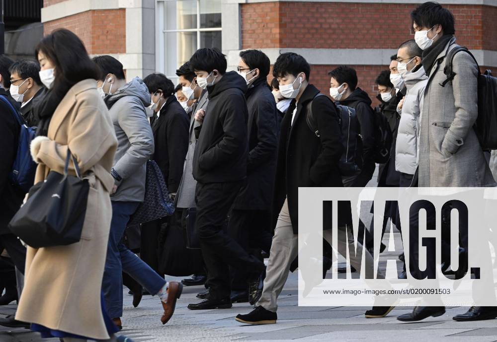 Scene of Tokyo People wearing face masks walk in front of JR Tokyo Station in the Japanese capital during the morning commuting hours of Jan. 20, 2023, amid the spread of coronavirus infections. A14AA0001386455P