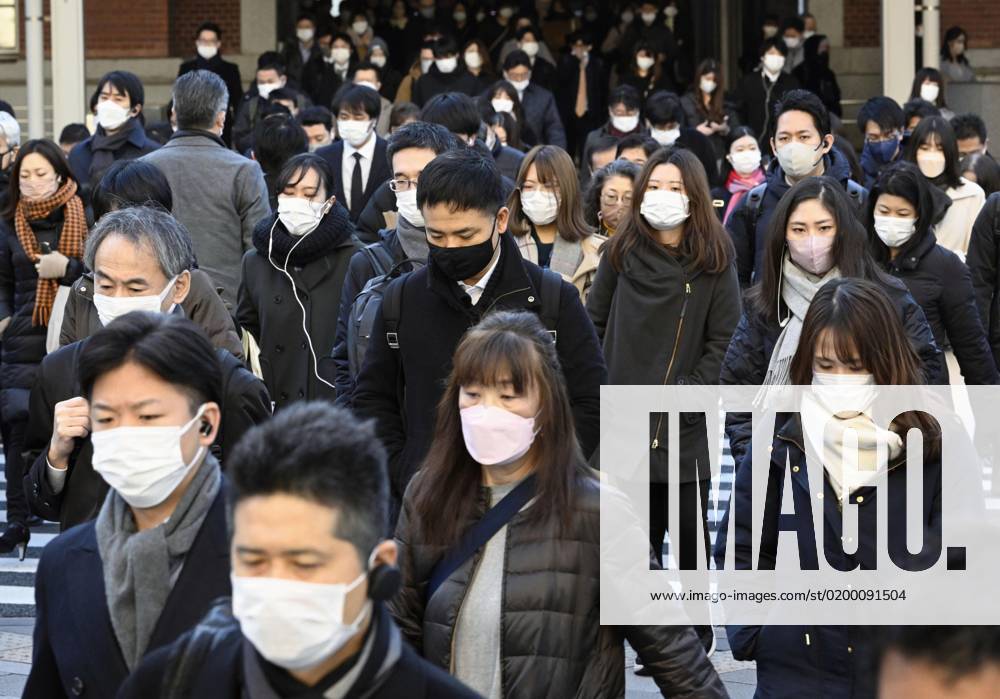 Scene of Tokyo People wearing face masks walk in front of JR Tokyo Station in the Japanese capital during the morning commuting hours of Jan. 20, 2023, amid the spread of coronavirus infections. A14AA0001386456P