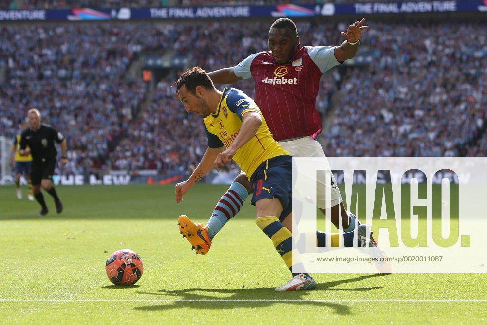 Christian Benteke of Aston Villa challenges Arsenal s Santi Cazorla - Arsenal vs. Aston Villa - FA Cup Final - Wembley Stadium - London - 30 05 2015 Pic Philip Oldham Sportimage .