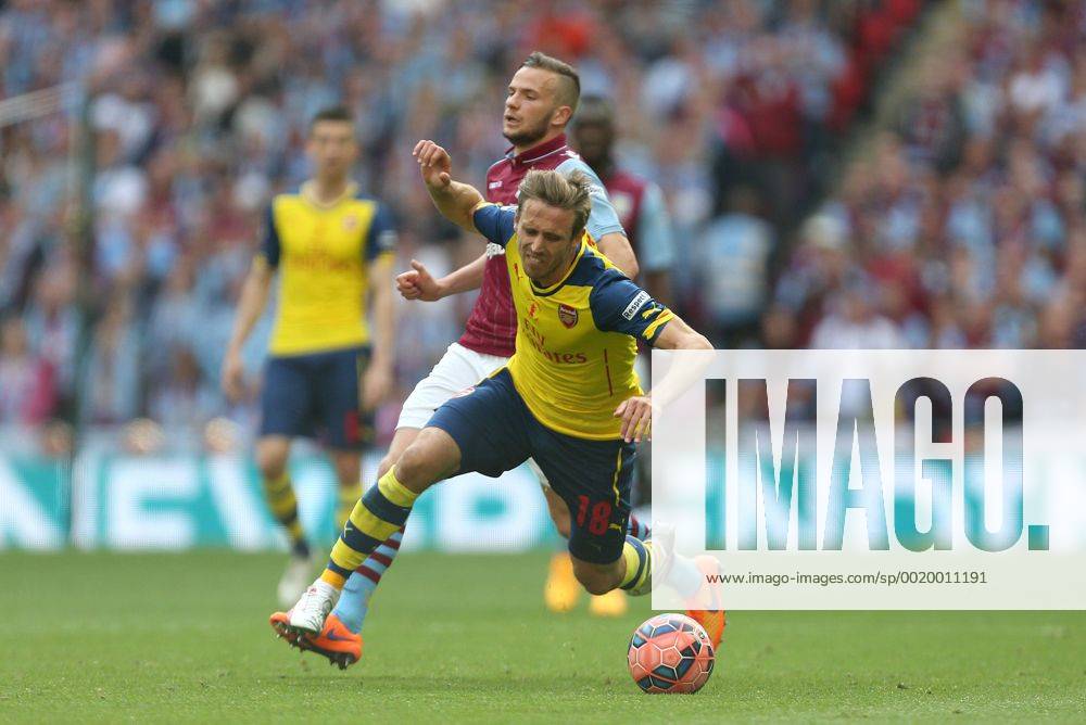 Tom Cleverley of Aston Villa earns a yellow card for his tackle on Arsenal s Nacho Monreal - Arsenal vs. Aston Villa - FA Cup Final - Wembley Stadium - London - 30 05 2015 Pic Philip Oldham Sportimage .