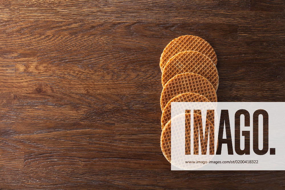 Waffles with caramel on wood Waffles with caramel on wooden background. Top view