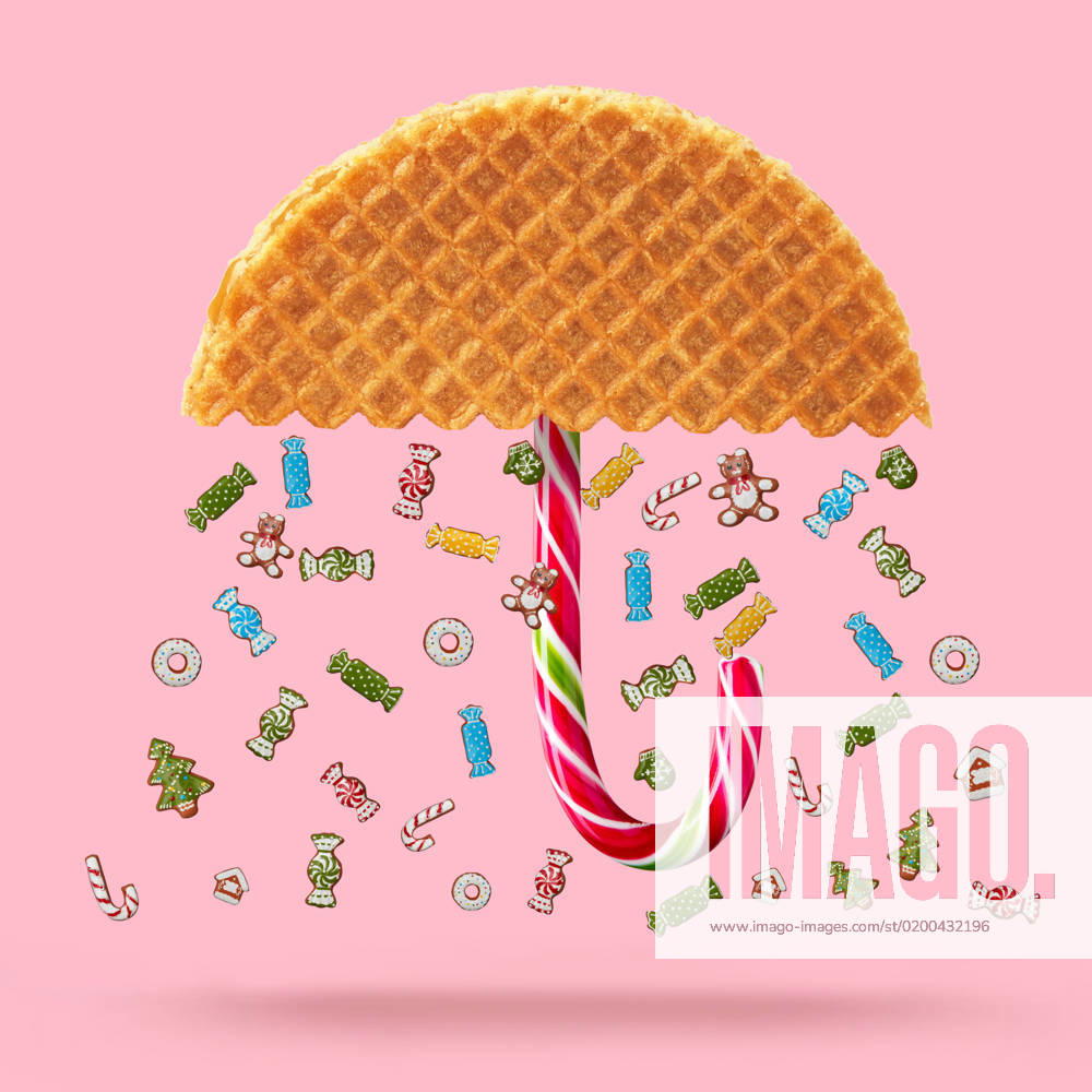 Waffle with caramel Christmas candy and Umbrella made of waffle on a pink background.