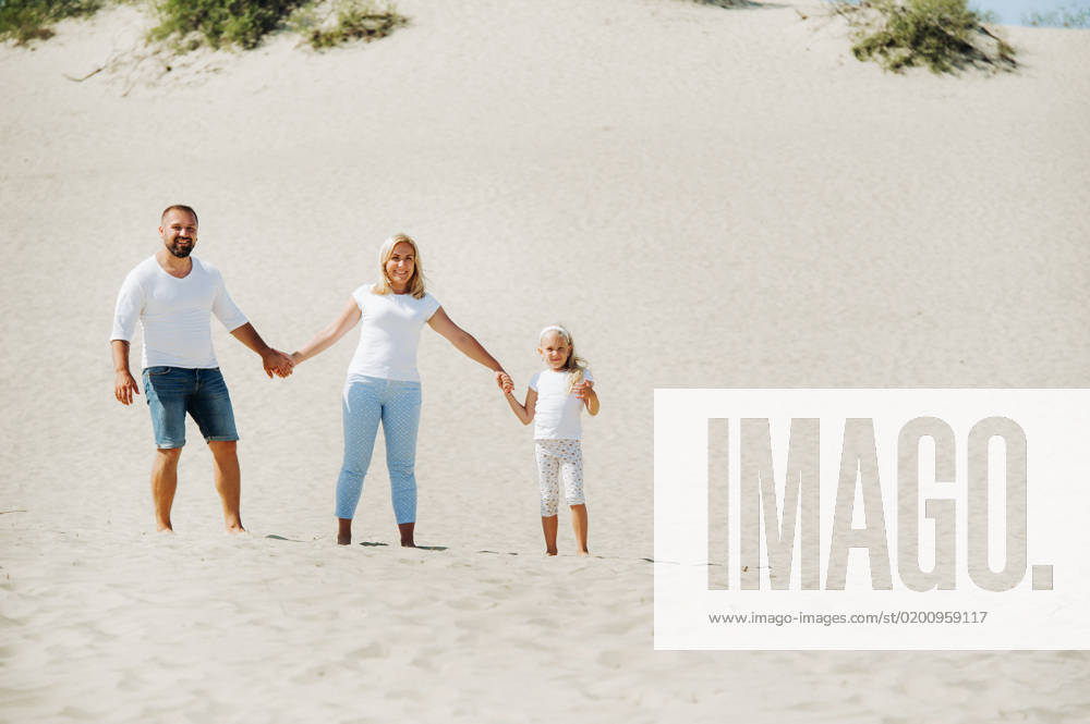 A happy family of three on the sand dunes of the Baltic sea near the city of Nida.Family trip to Europe.Lithuania., model released, , 40245508.jpg, family, young, vacation, travel, sand, together, shooting, family in white, self-portrait, photography, people, outdoor, lifestyle, Nida, Europe, happy, tourism, camera, Lithuania, dunes, dead dunes, father, smile, social, adult, trip, view, water, tourist, fun, summer, outside, happy family, holiday, desert, enjoy, person, sun, nature, parent, day, dad, happiness, sand dunes, Curonian spit