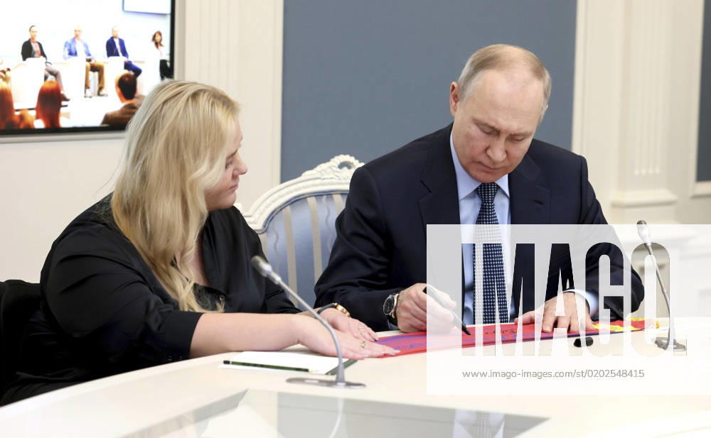 Russian President Vladimir Putin signs a banner for the president of the Moscow Region Club of CSKA Fans with Disabilities, Elena Popova during a meeting of the Supervisory Board of the autonomous non-profit organization Agency for Strategic Initiatives to Promote New Projects at the Kremlin, February 9, 2023 in Moscow, Russia. Moscow Russia - ZUMAp138 20230209_zaa_p138_048