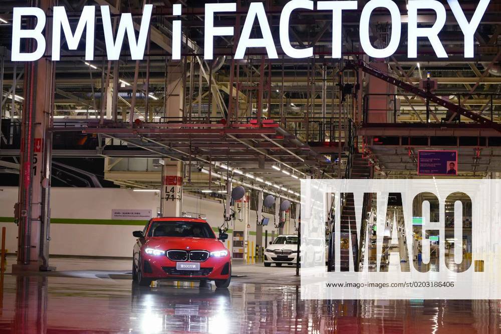 A BMW i3 eDrive 40L electric sedan, also the 5,000,000th vehicle produced by the BMW Brilliance Automotive Ltd. (BBA), runs by a sign reading BMW iFACTORY as it rolls off the assembly line at the BBA Tiexi plant on February 20, 2023 in Shenyang, Liaoning Province of China.