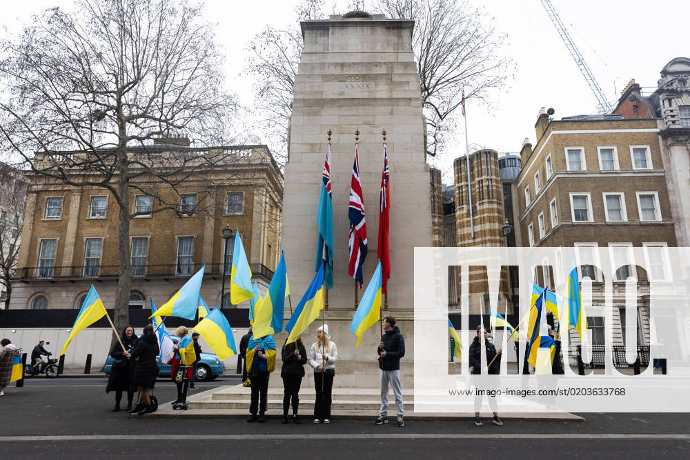 People hold Ukrainian flags as they observe a minute s silence in Whitehall opposite Downing Street in London. The world is marking the one-year anniversary of the full-scale Russian invasion of Ukraine today. London United Kingdom - ZUMAs197 20230224_zaa_s197_487