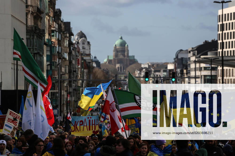 People hold signs, Ukrainian and Belarusian flags, and flags of the Chechen Republic of Ichkeria during a demonstration in occasion of the one-year anniversary of Russia s invasion of Ukraine in Brussels, Belgium, February 25, 2023. Brussels Belgium - ZUMAm177 20230225_zip_m177_007