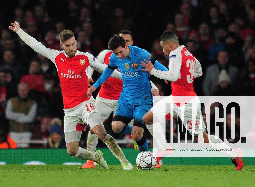 Football - 2015 2016 Champions League - Round of 16, First Leg: Arsenal vs. Barcelona Lionel Messi of Barcelona is challenged by Aaron Ramsey and Francis Coquelin at The Emirates. COLORSPORT ANDREW COWIE