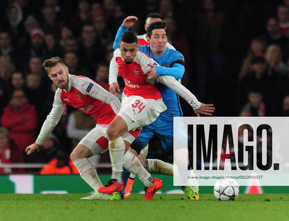 Football - 2015 2016 Champions League - Round of 16, First Leg: Arsenal vs. Barcelona Lionel Messi of Barcelona is challenged by Aaron Ramsey and Francis Coquelin at The Emirates. COLORSPORT ANDREW COWIE