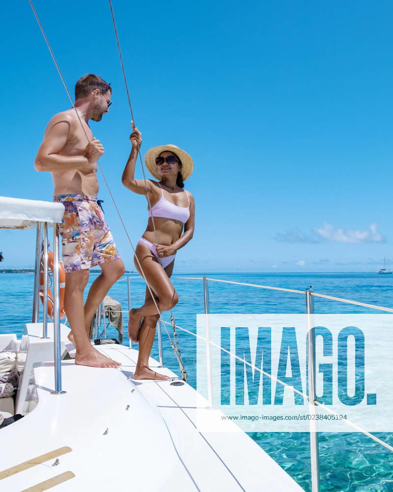 Couple man and woman on a boat during sailing trip in Mauritius couple man and woman on a boat during a sailing trip in Mauritius. man and woman on a sailing boat on a trip