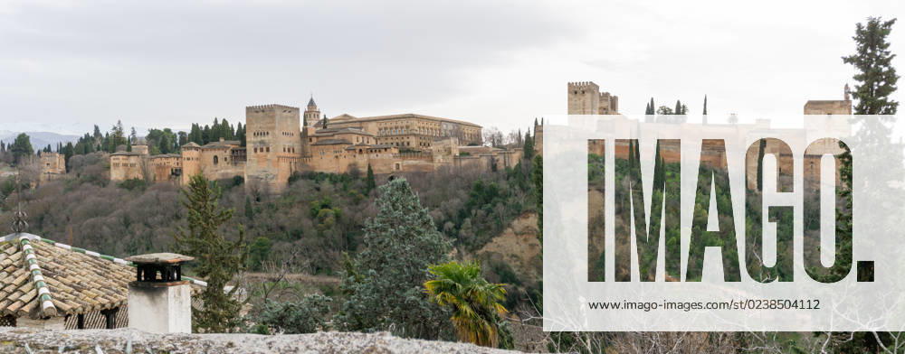 Panorama view of the Alhambra Palaces above Granada in Andalusia Granada, Spain - 4 February, 2021: panorama view of the Alhambra Palaces above Granada in Andalusia