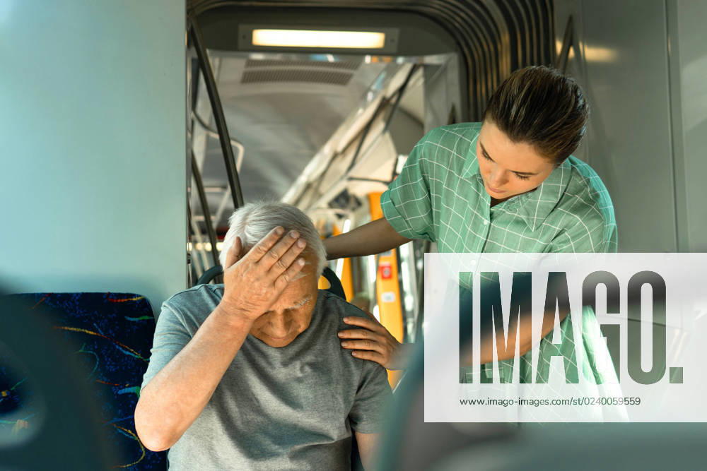 Young woman and senior man is feeling sick with migraine symptoms in public transport Anxious young woman and senior man is feeling sick with migraine symptoms in public transport ,model released, Symbolfoto