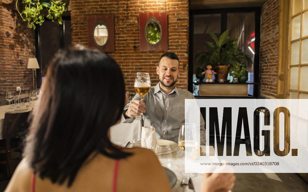 Couple toasting wineglasses enjoying dinner at restaurant model released, Symbolfoto property released, JCCMF09588
