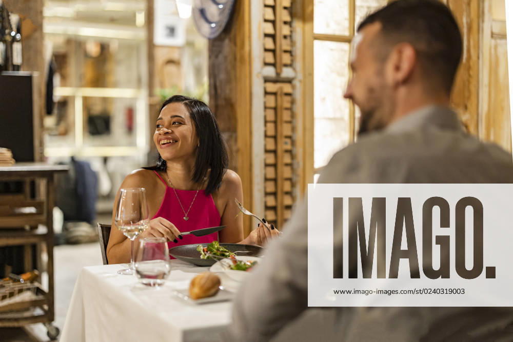Happy couple enjoying dinner date at restaurant model released, Symbolfoto property released, JCCMF09605