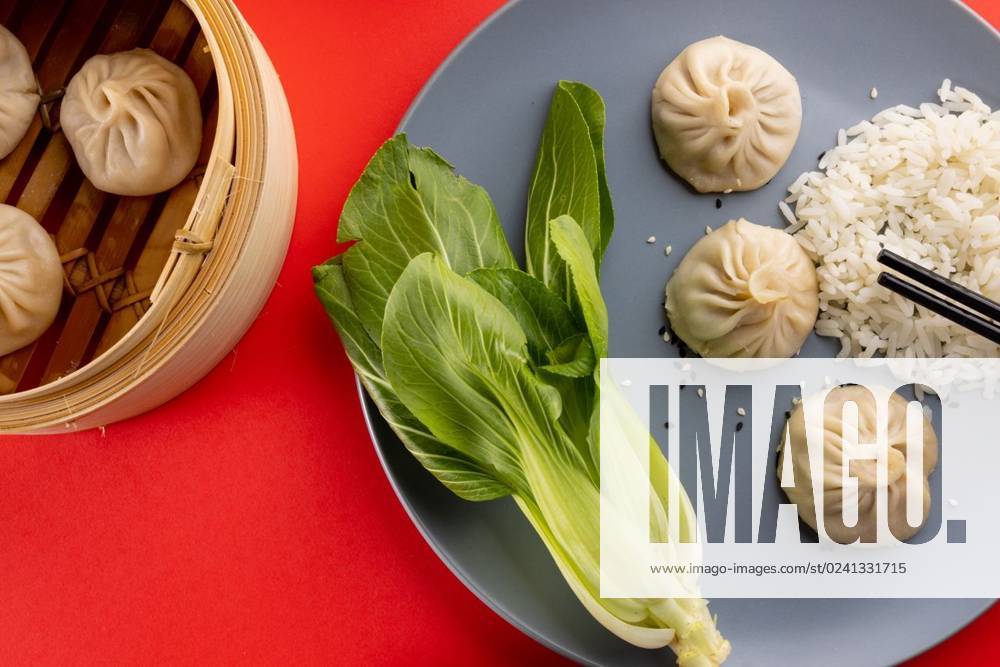 IMAGO Creative, Food, Dumplings Overhead view of asian dumplings, rice, endive and chopsticks on red background Overhead view of asian dumplings, rice, endive and chopsticks on red background. Asian tasty home cooked food and healthy eating., model released, , property released, Cape Town, South Africa, 14.07.2022, 3766918.jpg, overhead view,asian,dumpling,rice,endive,chopstick,red background,tasty,home,cooked,food,healthy eating,delicious,meal,cuisine,gourmet,fresh,dinner,lunch,snack,cooking,diet,dish,nutrition,sweet,healthy,dessert,organic,ingredient,plate,eat,meat,overhead,view,red,background,eating