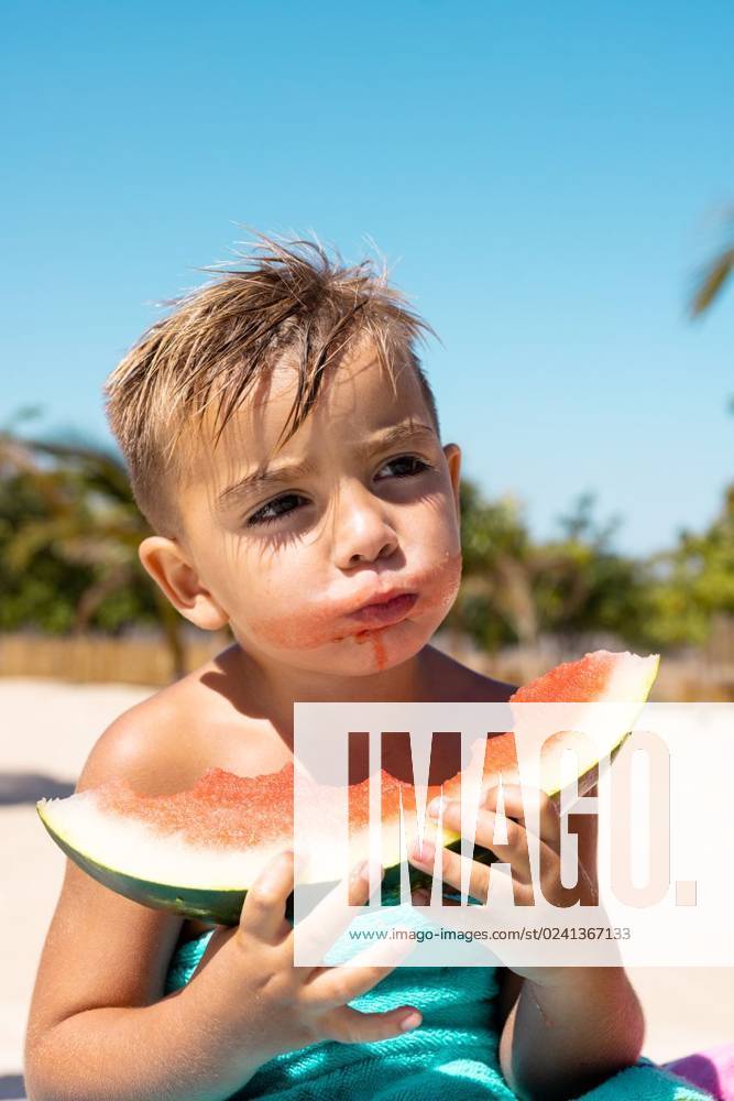Happy biracial boy eating watermelon by the swimming pool Happy biracial boy eating watermelon by the swimming pool. Spending quality time, lifestyle, childhood, summertime and vacation concept., model released, , property released, Cape Town, South Africa, 21.02.2023, 3976609.jpg, people,happy,boy,eating,watermelon,swimming pool,spending,quality time,lifestyle,childhood,summertime,vacation,concept,kid,young,leisure,fun,little,person,summer,holiday,healthy,travel,happiness,beach,family,sea,beautiful,sport,recreation,cheerful,biracial,swimming,pool,quality,time Child,Boy,Male,White
