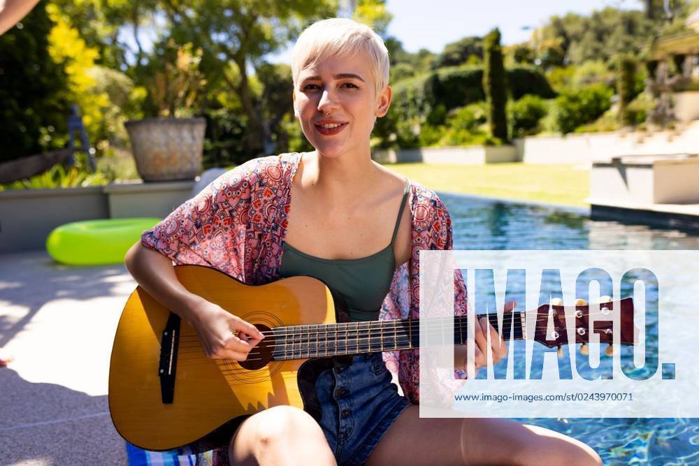 Portrait of happy caucasian woman having pool party, playing guitar and smiling in garden Portrait of happy caucasian woman having pool party, playing guitar and smiling in garden. Lifestyle, friendship, party and summer., model released, , property released, Cape Town, South Africa, 2023-01-25T22:00:00.000Z, 4017914.jpg, people,portrait,happy,caucasian woman,pool party,playing guitar,smiling,garden,lifestyle,friendship,summer,young,person,beautiful,adult,cheerful,happiness,attractive,fun,smile,nature,cute,beauty,pretty,outdoor,leisure,face,together,spring,green,caucasian,woman,pool,party,playing,guitar Non-binary,White