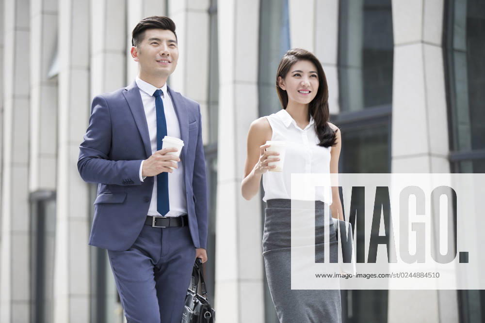 Confident Chinese business people walking outdoors Beijing China