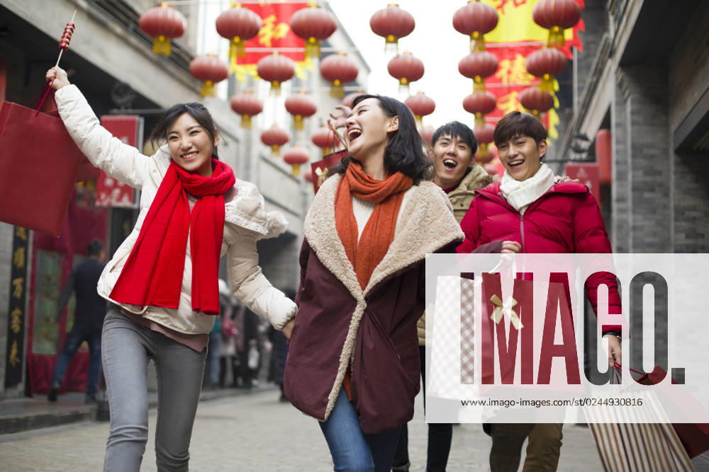 Happy young Chinese friends shopping for Chinese New Year Beijing China