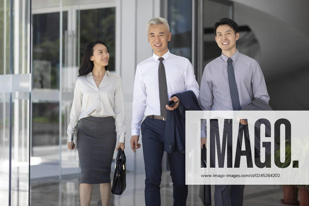 Confident Chinese business people walking Beijing China