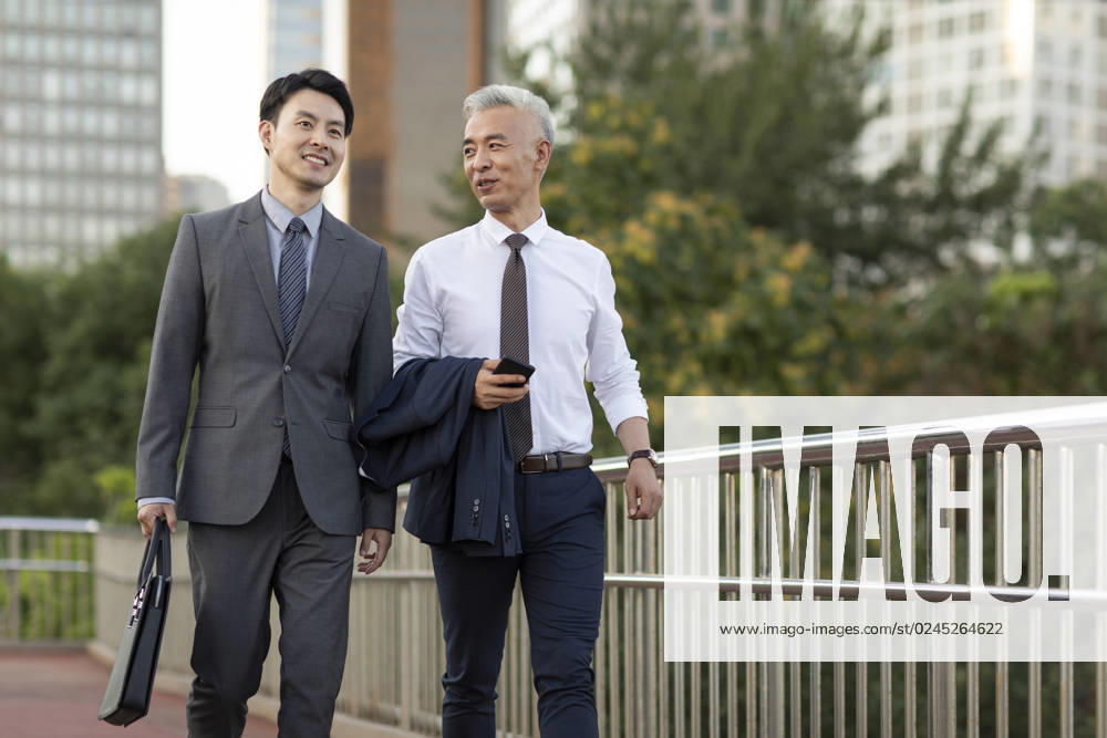 Confident Chinese business people walking outdoors Beijing China