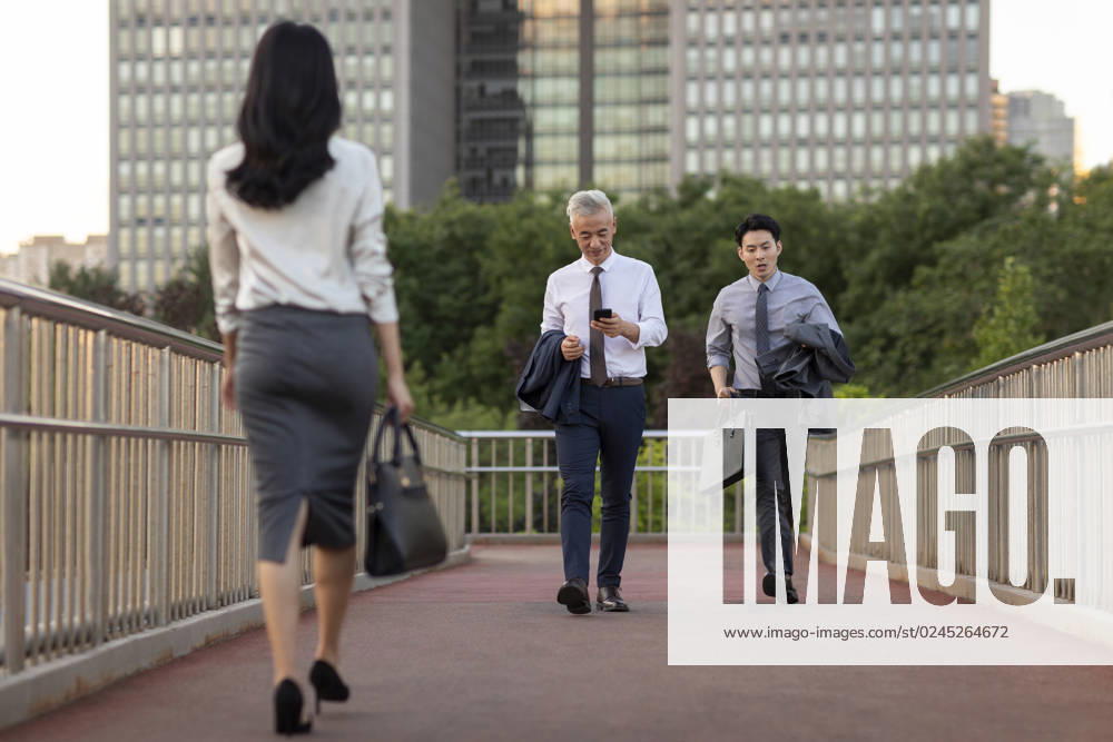 Confident Chinese business people walking outdoors Beijing China