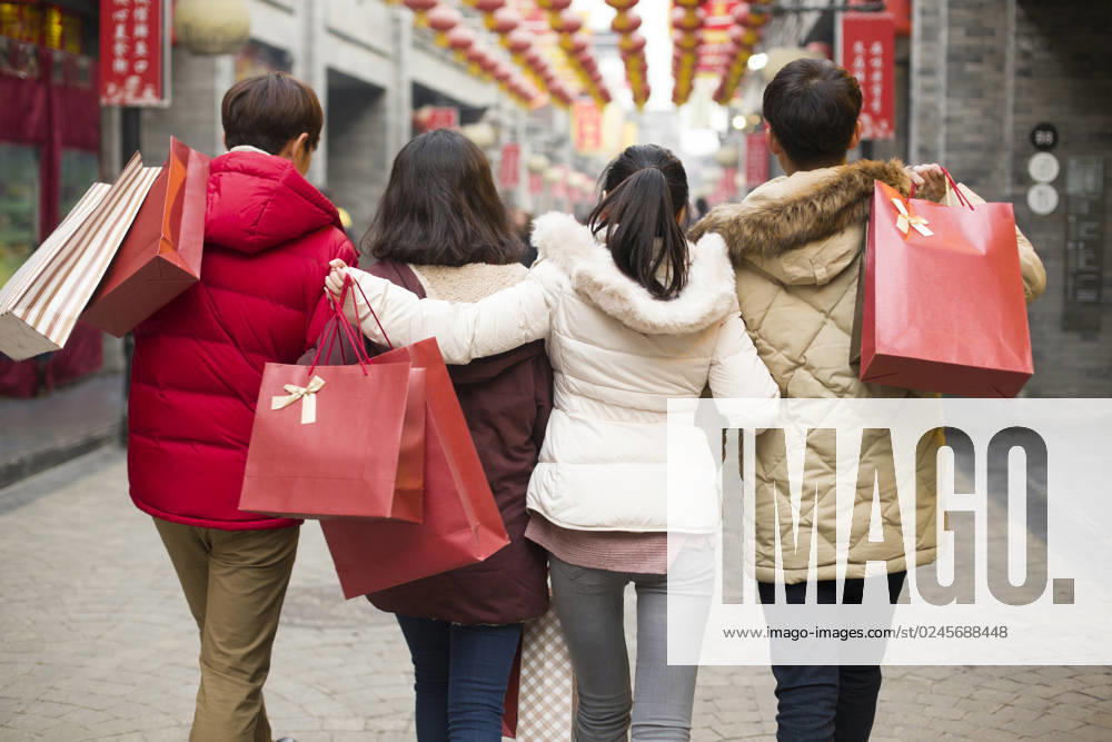 Happy young Chinese friends shopping for Chinese New Year Beijing China