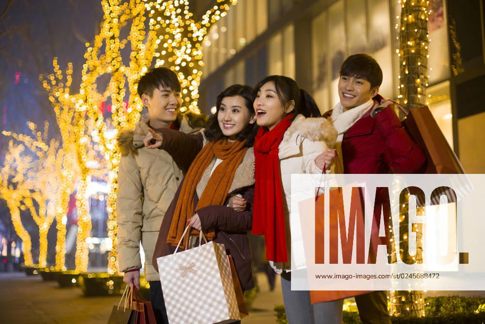 Happy young Chinese friends shopping for Chinese New Year Beijing China