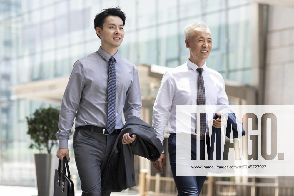 Confident Chinese business people walking outdoors Beijing China