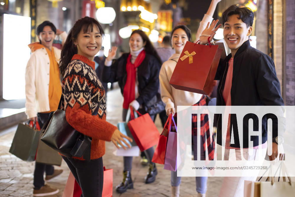 Happy young Chinese friends shopping for Chinese New Year Beijing China