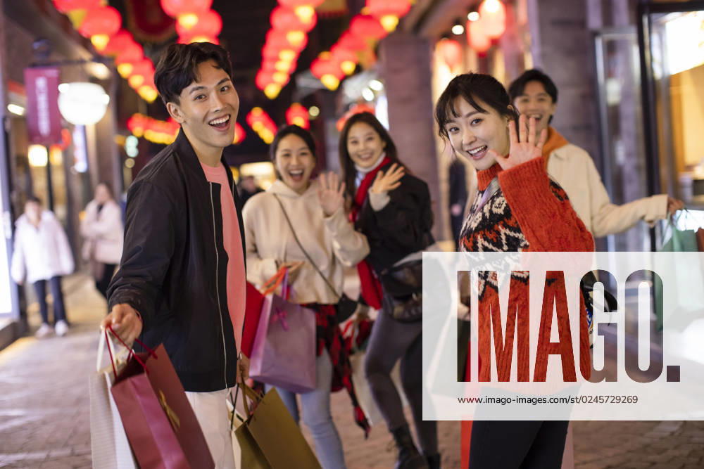 Happy young Chinese friends shopping for Chinese New Year Beijing China