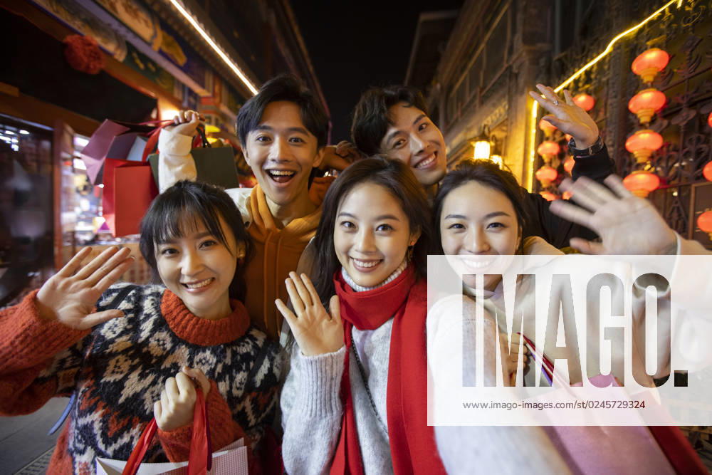 Happy young Chinese friends shopping for Chinese New Year Beijing China
