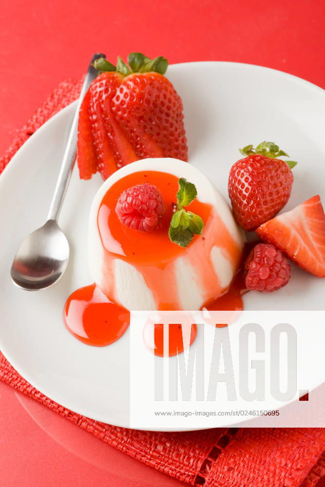 Photo of italian panna cotta dessert with strawberry sirup and mint leaf