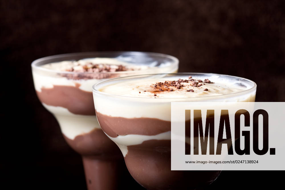 Chocolate and vanilla pudding in a parfait glass dusting of chocolate on top