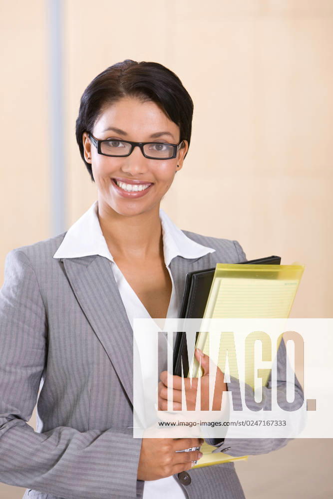 Portrait of a smiling businesswoman holding folder