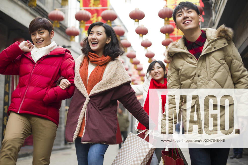 Happy young Chinese friends shopping for Chinese New Year Beijing China