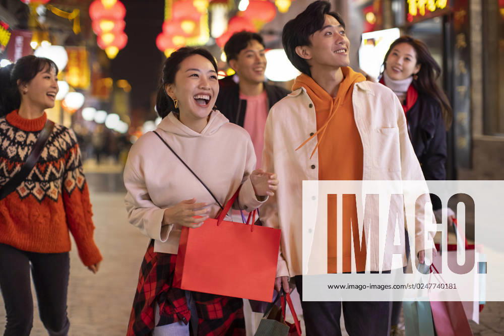 Happy young Chinese friends shopping for Chinese New Year Beijing China