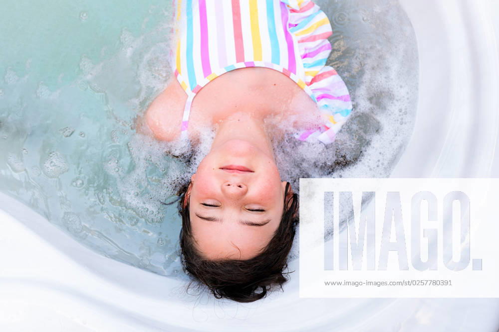 MR_ID14015_13411_ArhaneUnzueta.jpg Top view of relaxed girl in swimwear resting with closed eyes lying in water of pool in bathtub, Model released HodeiUnzueta_ID14015_422838_007