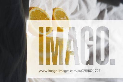 A closeup of a lemon juice with lemons on the bed *** einer closeupe des einer Zitrone Saft mit Zitronen am der Bett 4983824 RECORD DATE NOT STATED