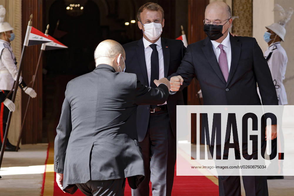 French President Emmanuel Macron in Baghdad - Iraq Iraqi President Barham Saleh (R) greets a member of French President Emmanuel Macron s (C) delegation during a welcoming ceremony for the French leader in Baghdad on August 28, 2021. - Macron is among leaders set to attend a regional summit today in Iraq, with the Taliban s takeover of Afghanistan and a deadly jihadist attack in Kabul overshadowing the meeting. Photo by Ludovic Marin pool ABACAPRESS;COM Baghdad Iraq