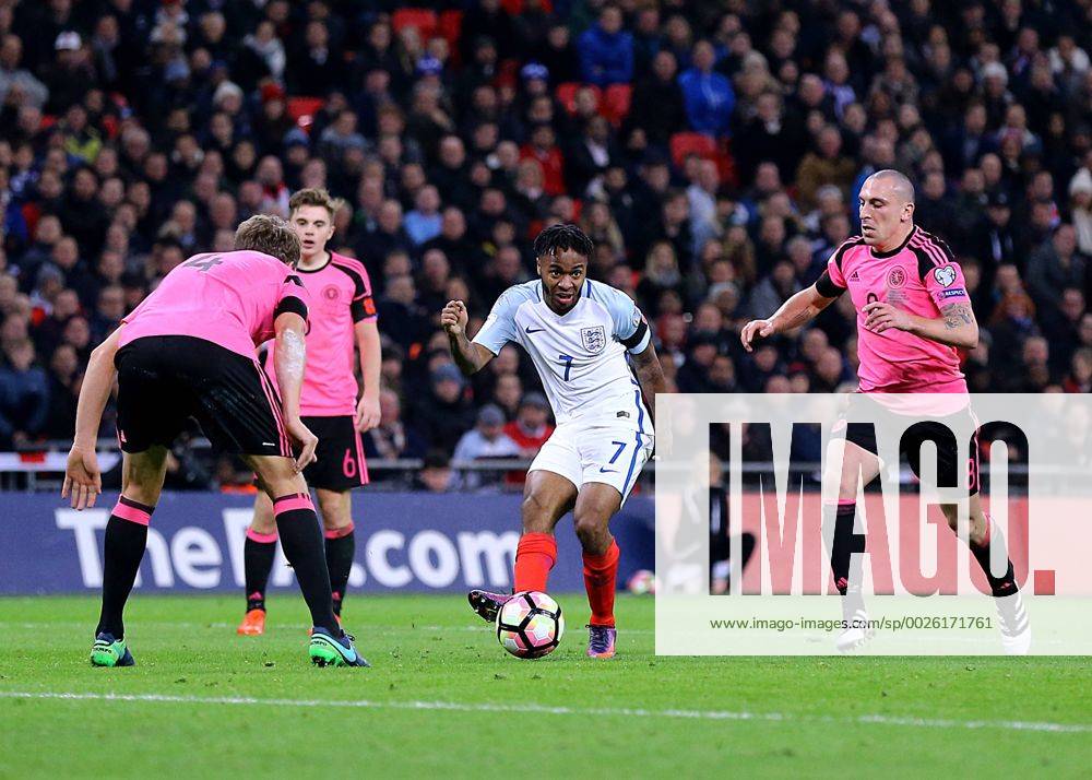 Wembley Stadium, London, England. World Cup Qualifying Football. England versus Scotland. Raheem Sterling of England crosses into the Scotland area, as Scotland s Christophe Berra and Scott Brown him down Kertonx ActionPlus11808617