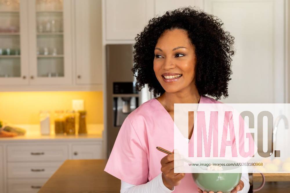 Happy biracial female medical worker in scrubs eating bowl of breakfast cereal in kitchen at home Happy biracial female medical worker in scrubs eating bowl of breakfast cereal in kitchen at home. Medical services, food, lifestyle and domestic life, unaltered., model released, , property released, Cape Town, South Africa, 2023-03-22T22:00:00.000Z, 4106201.jpg, people,happy biracial,female,medical worker,scrub,eating,bowl,breakfast,cereal,kitchen,home,service,food,lifestyle,domestic life,unaltered,meal,cooking,healthy,delicious,fresh,diet,nutrition,drink,tasty,ingredient,organic,dinner,table,lunch,gourmet,vegetarian,cuisine,snack,restaurant,sweet,happy,biracial,medical,worker,domestic,life Young Adult,Woman,Female,Multiracial